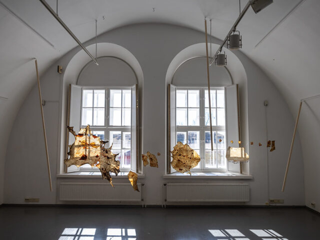 a gallery space with hanging pieces of art that is brown taken during Open Studios / Winter 2025.